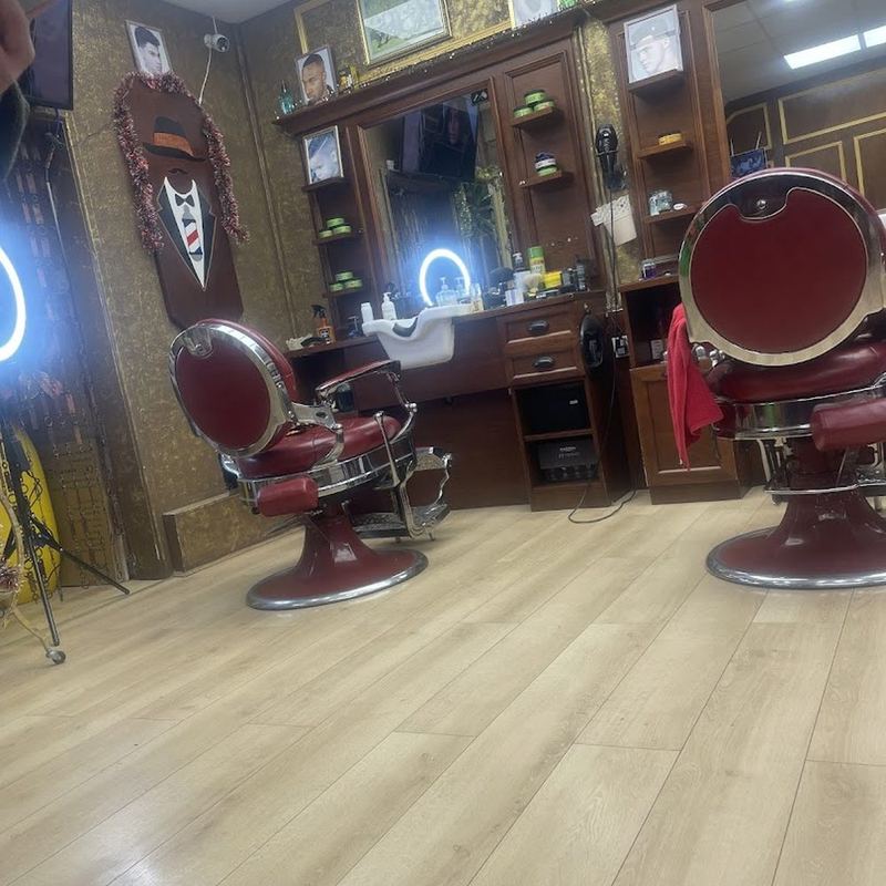 Vintage red-leather barber chairs and mirrors at Boss Barbers, Bath