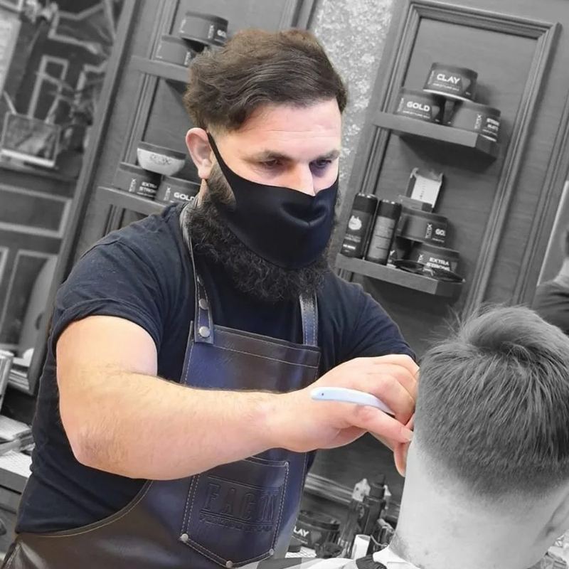 Barber cutting a client's hair at Boss Barbers, Bath