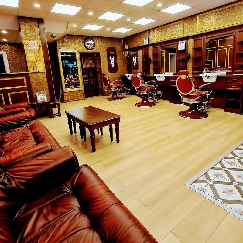 Inside Boss Barbers: leather sofa, barber chairs and warm wood interior